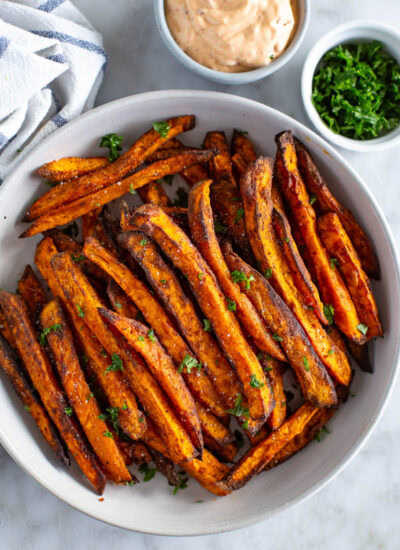 Overhead shot of sweet potato fries with a side of dipping sauce