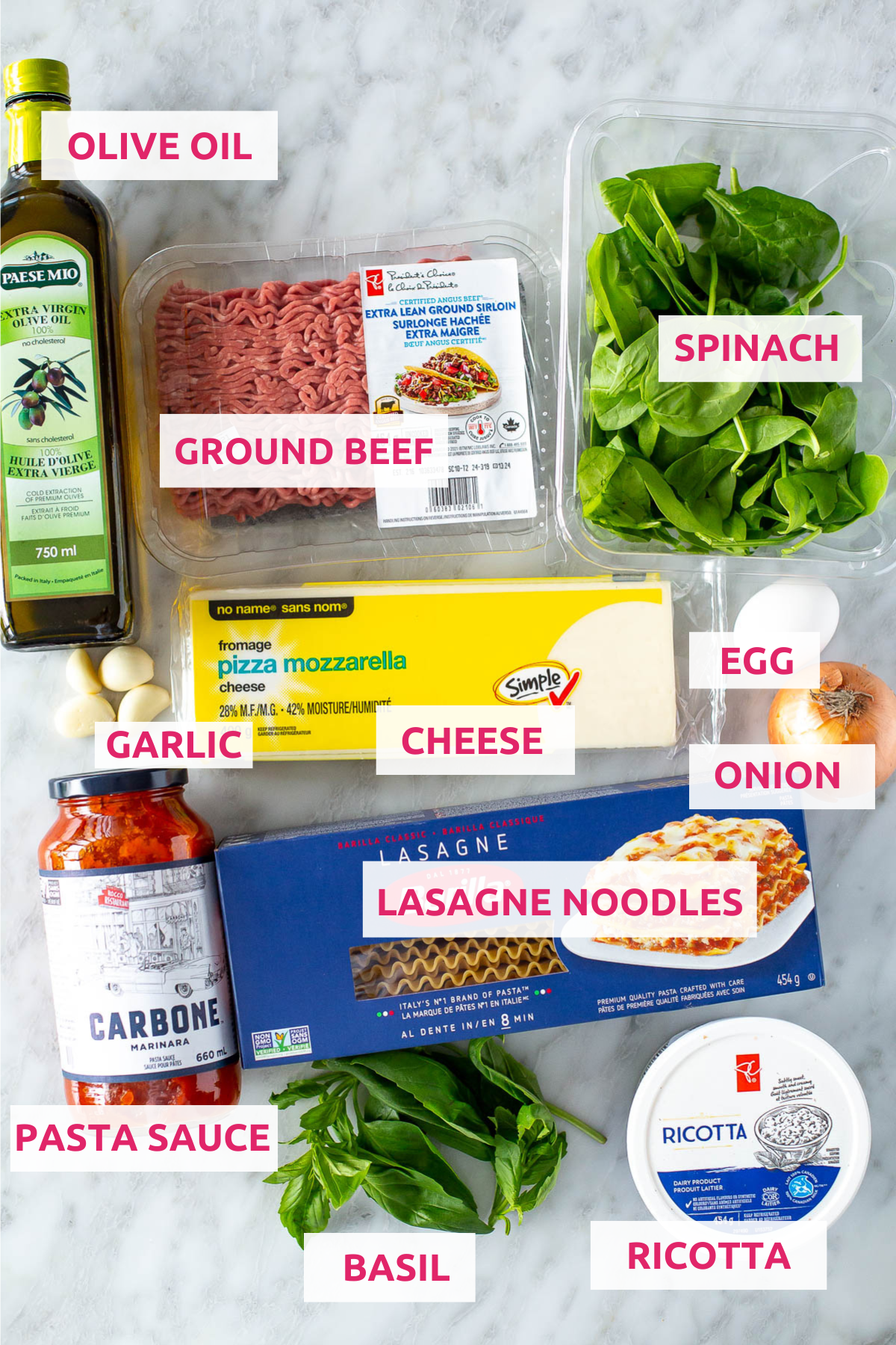 Ingredients for lasagna roll-ups laid out on a countertop, including lasagna noodles, ricotta, ground beef, spinach, and mozzarella cheese.